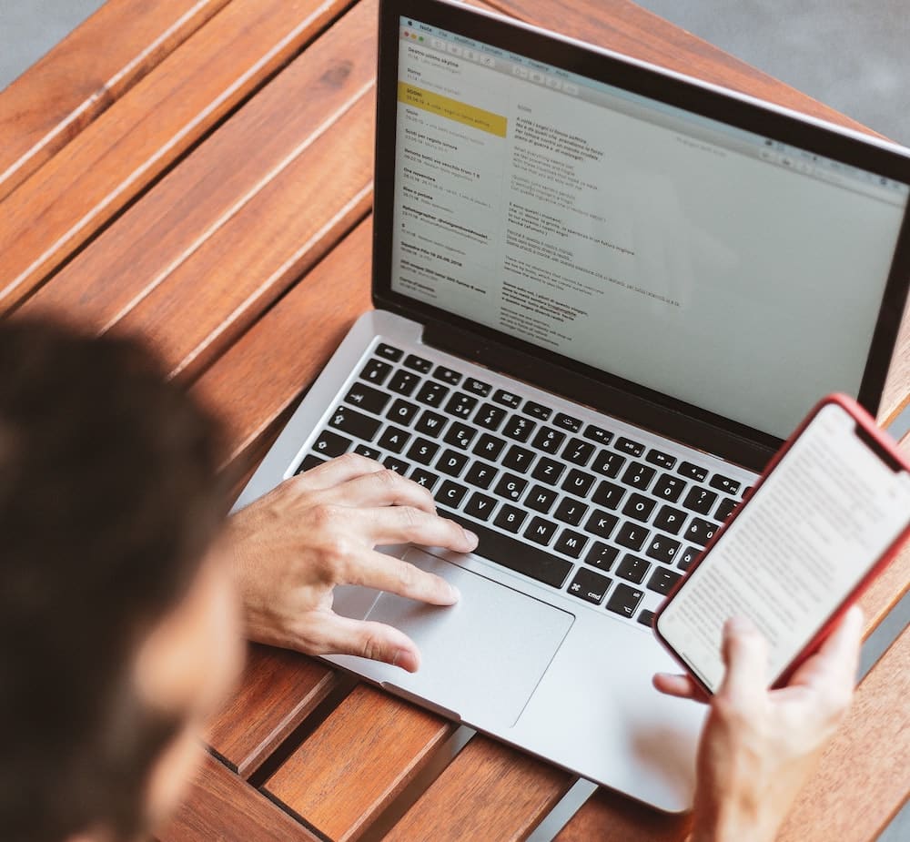 man on laptop sending emails